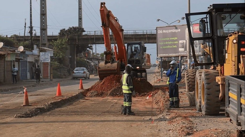 Escavadora e equipa em obra de construção de estrada